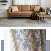 Close-up of a light blue and beige cotton-linen retro floral curtain with fringed tassels.