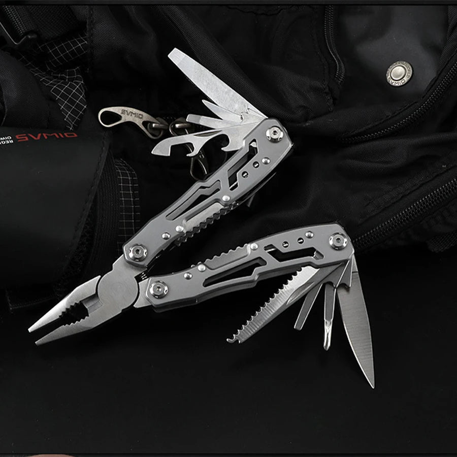 A stainless steel pocket multitool with pliers is shown against a black fabric background.