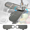 A silicone sink faucet mat with a rotating splash guard is shown in use over a kitchen sink.