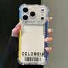 A hand holds a clear phone case featuring the word COLOMBIA and a barcode.