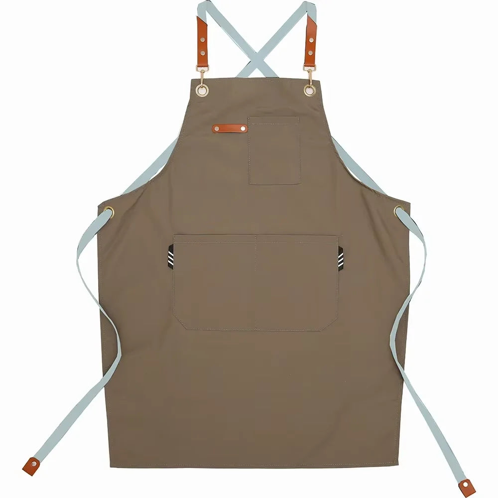 A brown cotton canvas apron with adjustable straps and multiple pockets for kitchen or salon use.