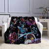 A black flannel throw blanket featuring various images of the Kiss band members and album art.