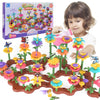 A child is building a colorful flower garden using wooden pieces and plastic flowers.