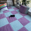 Soft plush interlocking floor tiles in shades of purple and light blue on a floor.