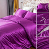 A vibrant purple silky duvet cover set featuring corner ties and a zipper, displayed on a bed.