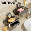 Chrome wall-mounted soap dish with a drain tray and a pink soap bar