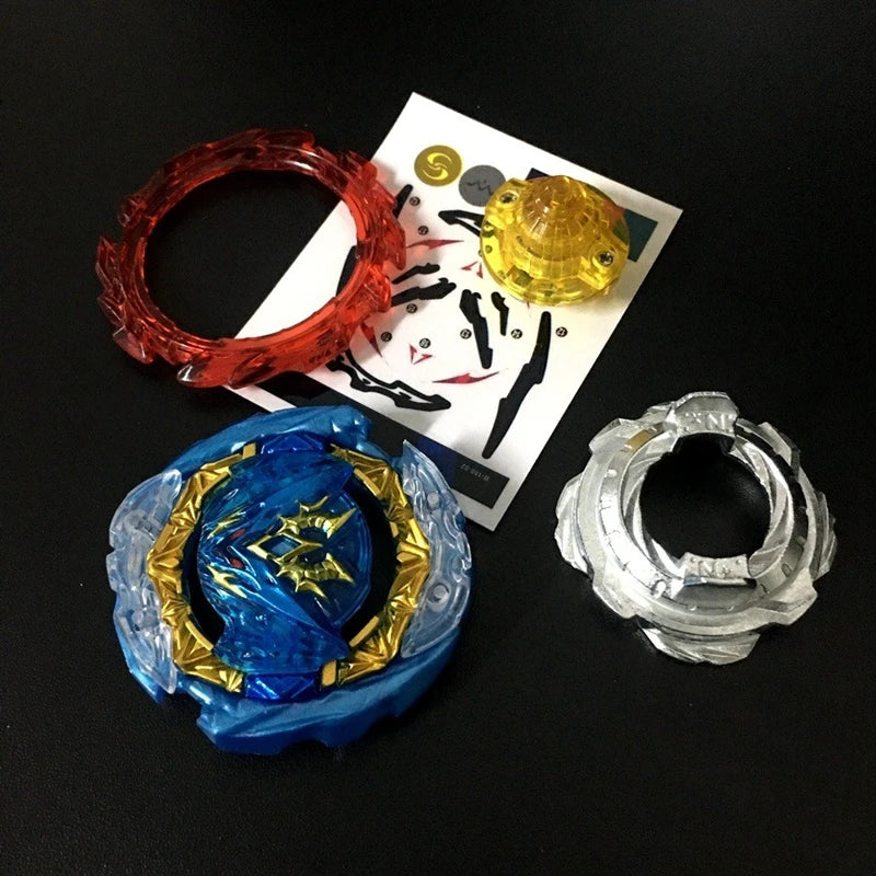 A collection of metal battle spinning tops, including a red ring, a yellow sphere, and a blue top with gold accents.