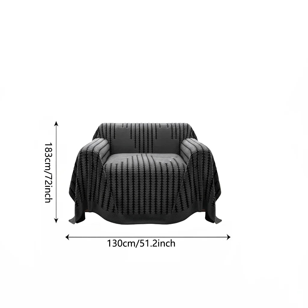 A black bohemian striped sofa cover or throw with a textured weave shown flat.