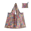 A reusable shopping tote bag in brown and purple floral pattern with an attached small carry pouch.