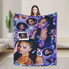 A purple and black patterned fleece throw blanket featuring various stylized portraits of a woman.