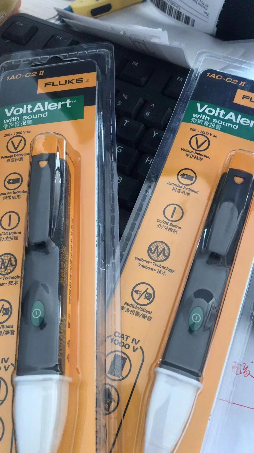 A close-up view of a Fluke VoltAlert non-contact voltage tester pen with yellow and black packaging.