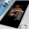 A black gaming mouse pad featuring artwork from The Boondocks with characters in a dramatic scene.