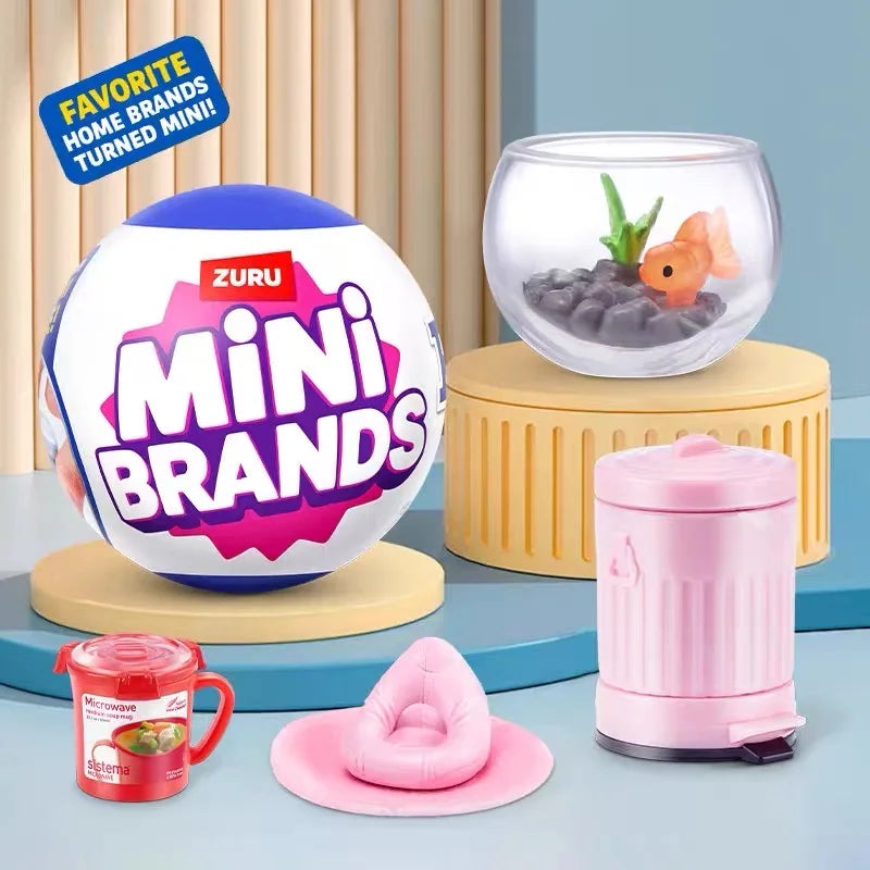 A collection of Mini Brands toys, including a spherical toy, a glass bowl with an orange item, and a pink microwave-like devi