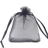 A clear black organza drawstring gift bag with a gathered top and long ties.