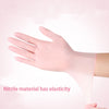 A hand wearing a pink disposable nitrile glove demonstrates the elasticity of the material.