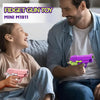 A young girl is playing with a purple fidget gun toy while a man watches her.