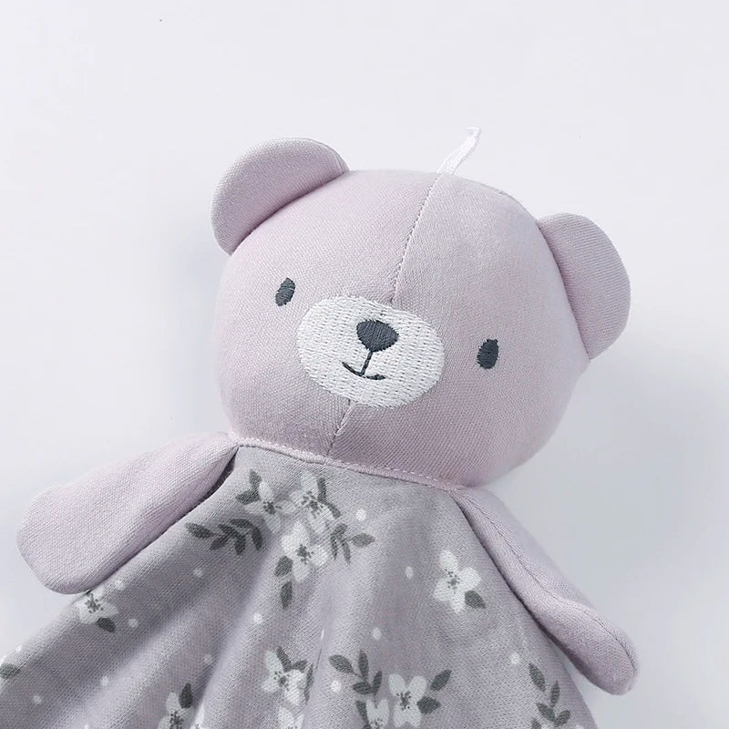 A soft lavender stuffed animal with a face and a floral patterned fabric body.