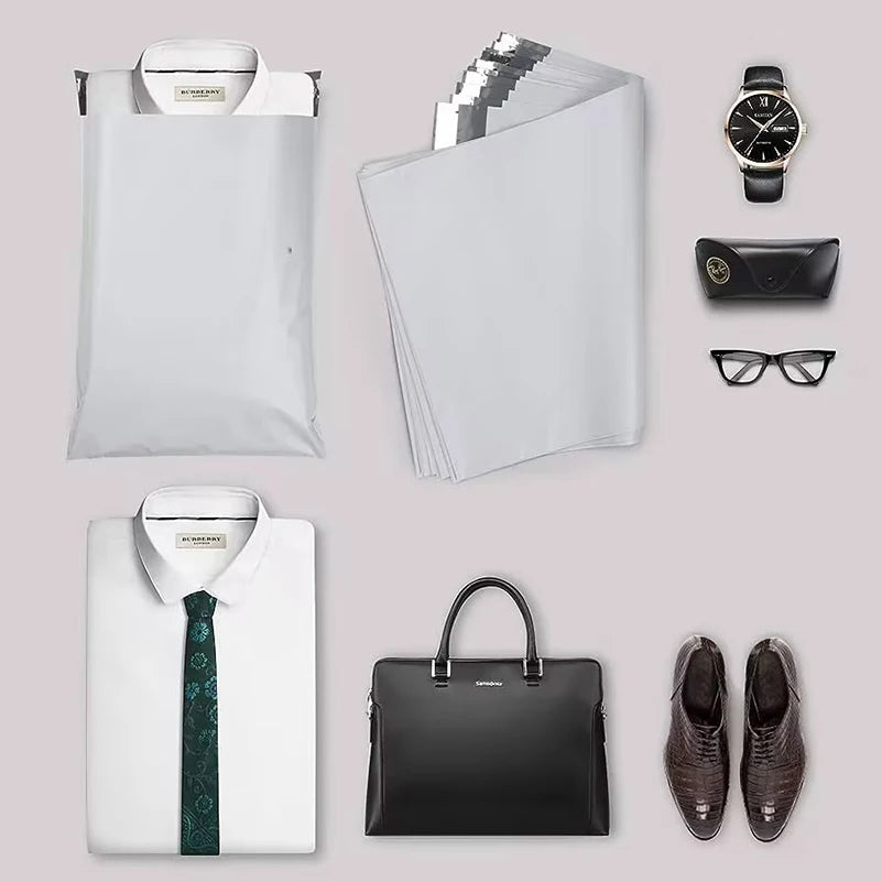 A collection of self-sealing mailing bags, a black leather wallet, and eyeglasses displayed on a light gray background.