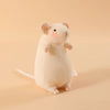 A small, fluffy white plush mouse stuffed animal with a keychain loop against a light beige background.