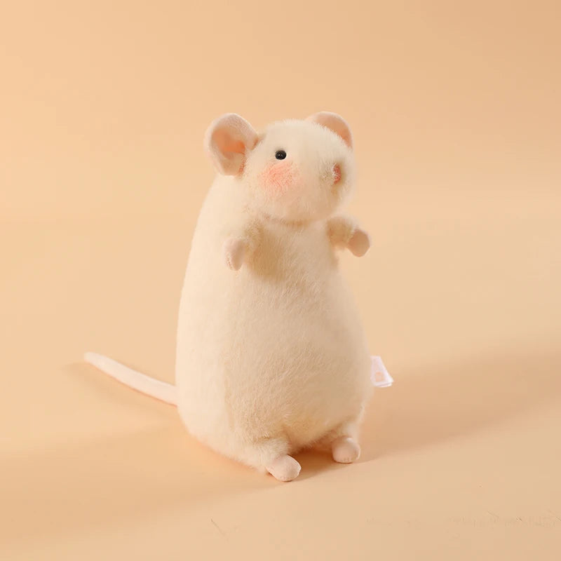 A small, fluffy white plush mouse stuffed animal with a keychain loop against a light beige background.