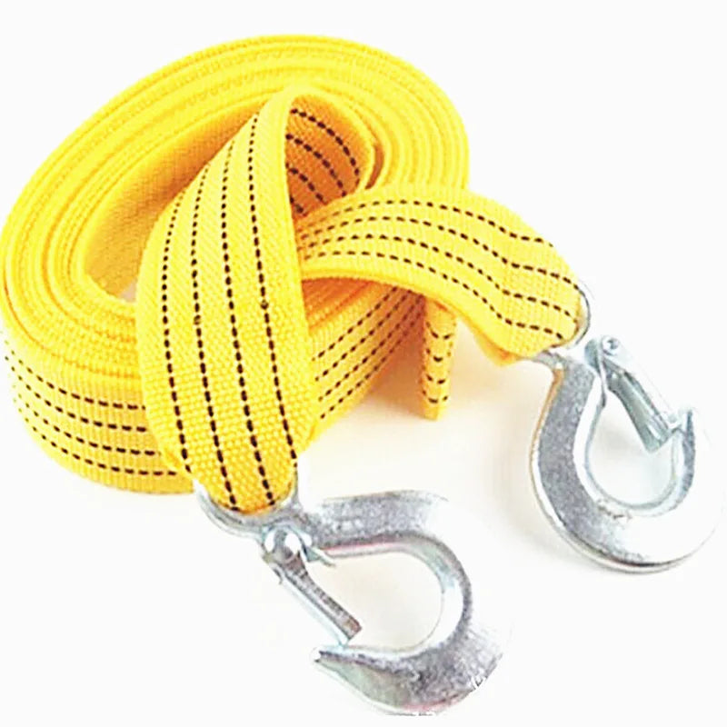 Yellow heavy-duty vehicle recovery towing strap coiled and with metal hooks