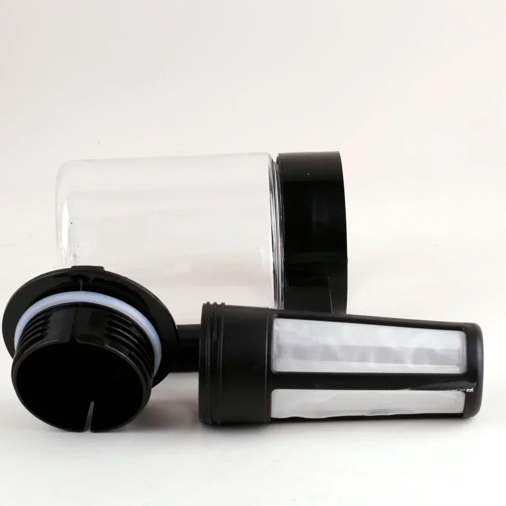 A clear glass container and black filter assembly for a cold brew coffee maker.