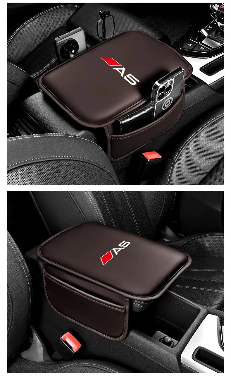A dark brown car armrest box mat with an AS logo and a storage pocket is shown in a car interior.
