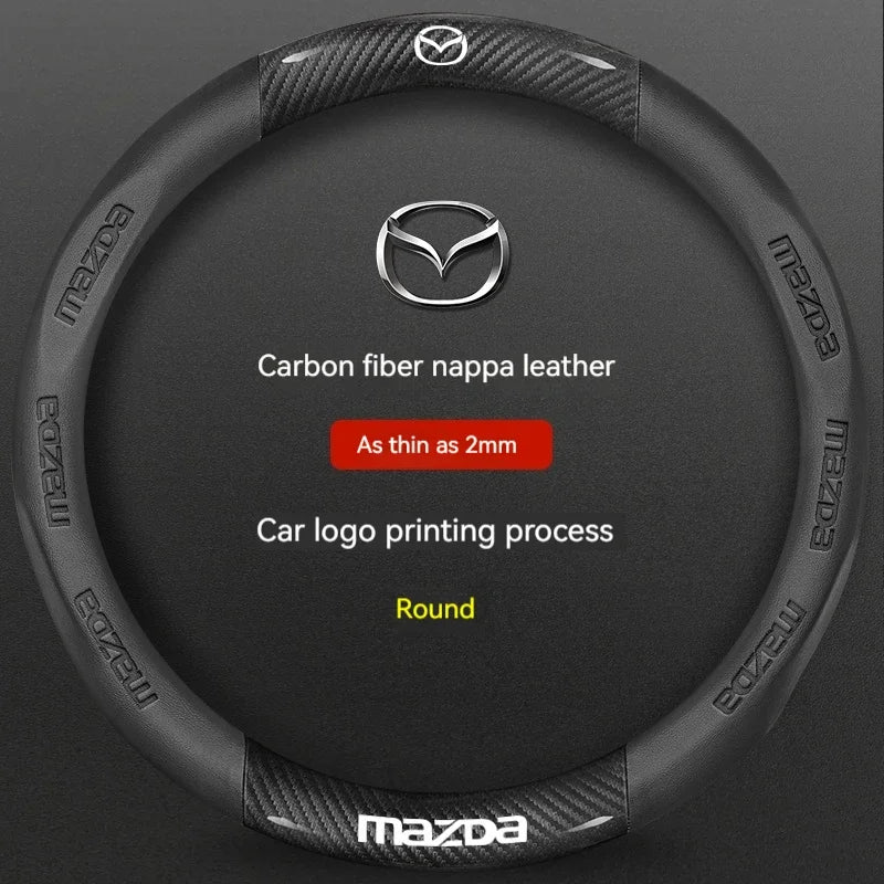 Black carbon fiber and leather steering wheel cover with a silver Mazda logo printing process