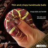 A hand holds a thin and crispy handmade ball with yellow stripes, demonstrating its texture.