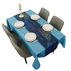 A blue geometric waterproof tablecloth set for a dining table with place settings and a candlestick.
