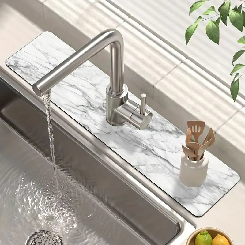 A modern stainless steel faucet is shown pouring water onto a marble drying mat placed over a kitchen sink.
