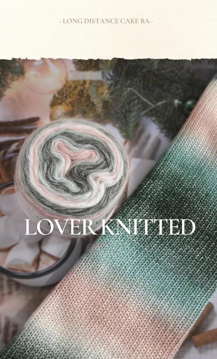 A close-up of a hand-knitted yarn featuring a soft gradient of pink, green, and white colors.