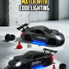 A black RC drift truck is illuminated by blue LED lights in a studio setting.