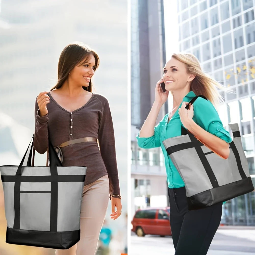 A blonde woman carrying a large black and gray insulated cooler bag while walking in an urban setting.
