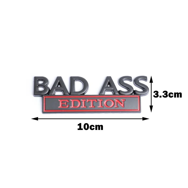 A black 3D metal badge emblem with the text BAD ASS EDITION and dimensions shown.