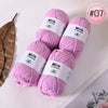 Pink Milk Cotton yarn skeins for knitting and crochet displayed on a white surface.