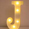 A glowing yellow LED letter J night light with multiple illuminated dots.