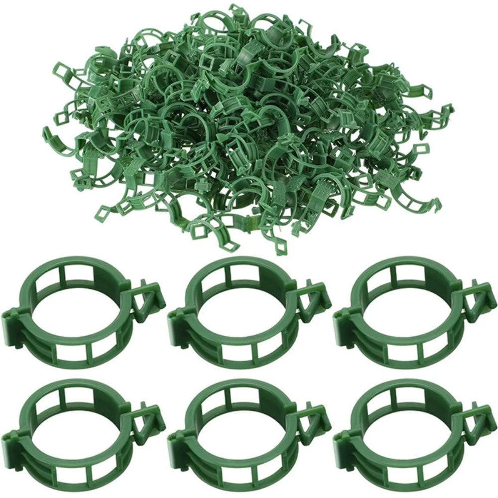 A pile of green reusable plant clips for garden support and vine fixing