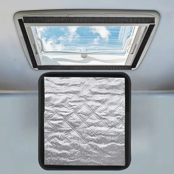A foldable RV roof vent cover installed in a ceiling, showing an open view of the sky and clouds.