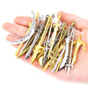 A hand holds a collection of 16 assorted gun-shaped charms for DIY jewelry making in silver and gold finishes.