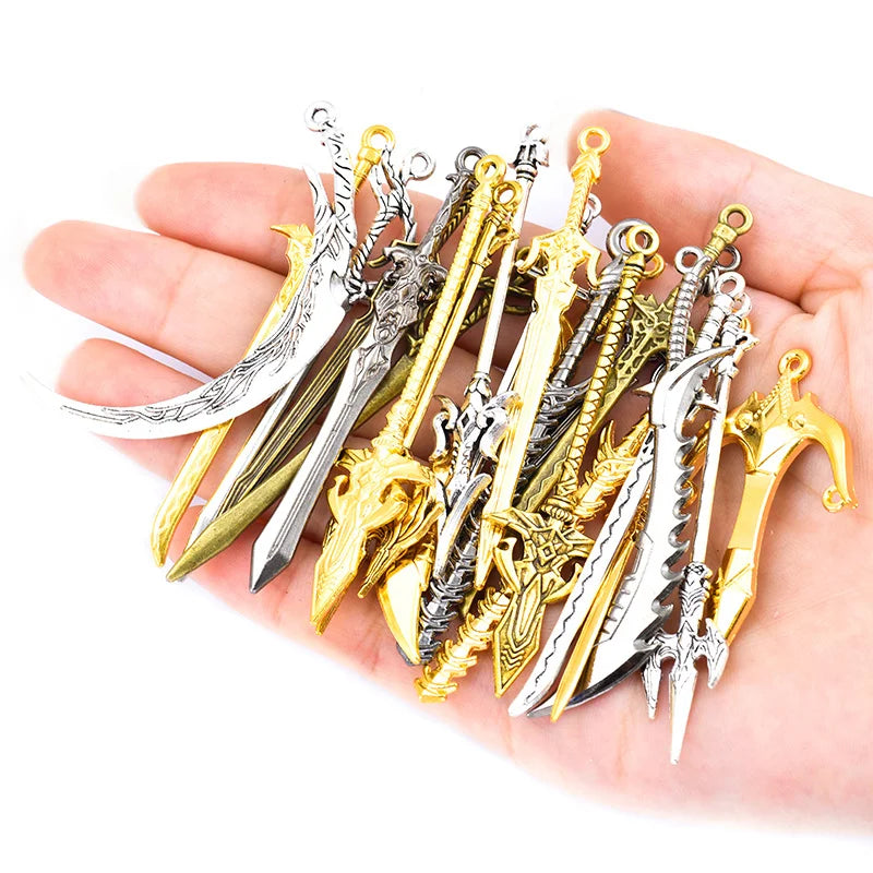 A hand holds a collection of 16 assorted gun-shaped charms for DIY jewelry making in silver and gold finishes.
