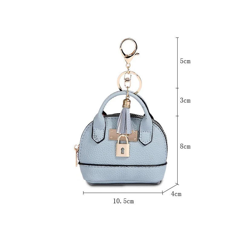 Light blue compact PU leather earbud case with a gold-tone keychain attached.