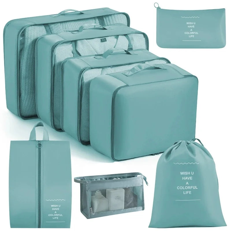 A set of teal travel packing cubes and storage bags for organizing items.