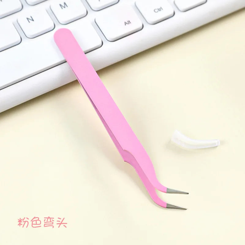 A pink precision craft tool with straight and curved tips is shown next to a white computer keyboard.