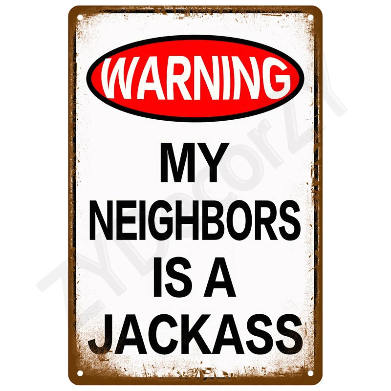 A vintage metal tin sign with a warning label that reads WARNING MY NEIGHBORS IS A JACKASS