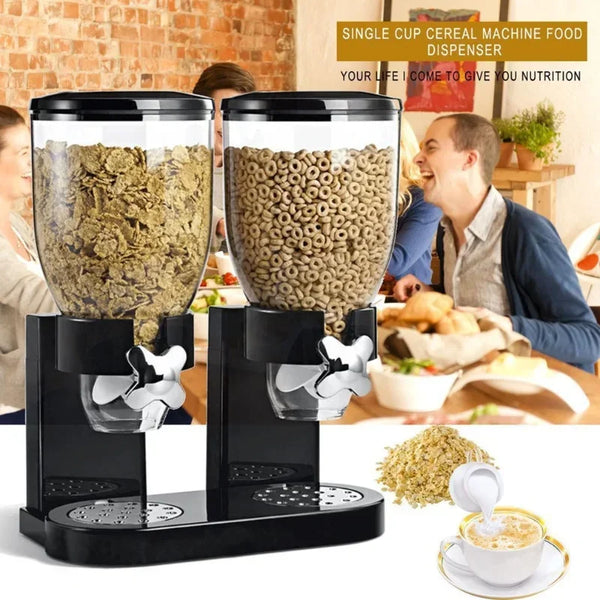 Máquina dispensadora de cereal de una sola taza negra con una taza de vidrio transparente y base, mostrada en una cocina.