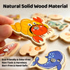 Hand holding a wooden magnetic fishing toy shaped like a crab and a fish, demonstrating an eco-friendly learning game.