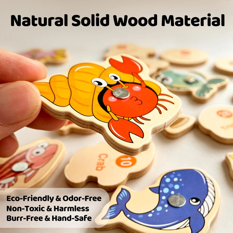 Hand holding a wooden magnetic fishing toy shaped like a crab and a fish, demonstrating an eco-friendly learning game.