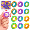 A hand holds a silicone fidget ring in various colors, demonstrating the product for stress relief.