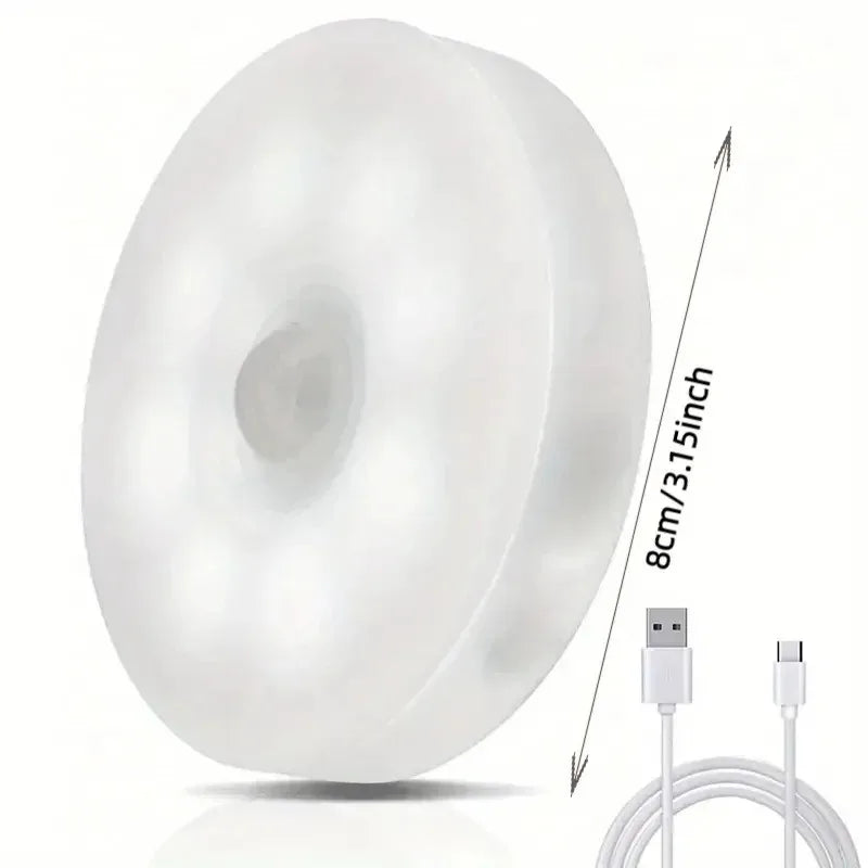 A white motion sensor LED night light with a USB rechargeable battery, shown from the top view.